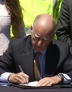 California Governor Jerry Brown signing the high speed train bill.